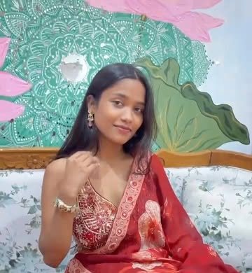 Woman in a red floral organza saree