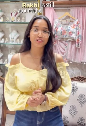 Inside the store, with jewellery shelves and blouses on display